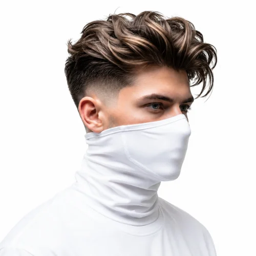 Man with a Ninja-inspired low taper fade haircut featuring textured hair on a white background.