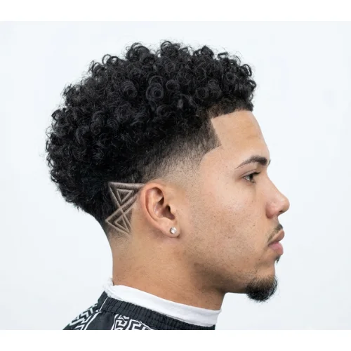 Black man with a low taper fade haircut featuring a shaved hair design