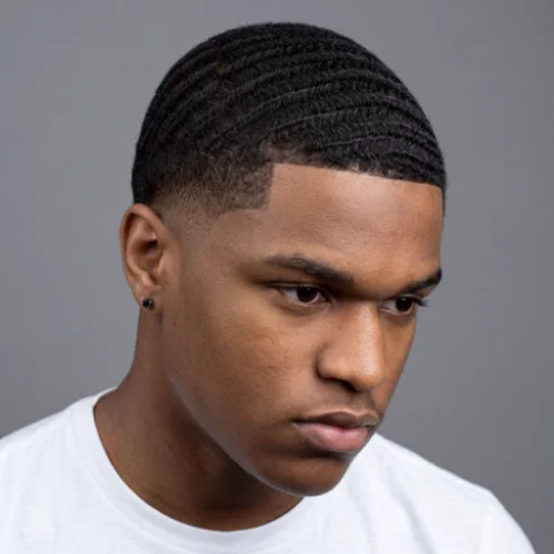 Black man with 360 waves and a low taper fade haircut