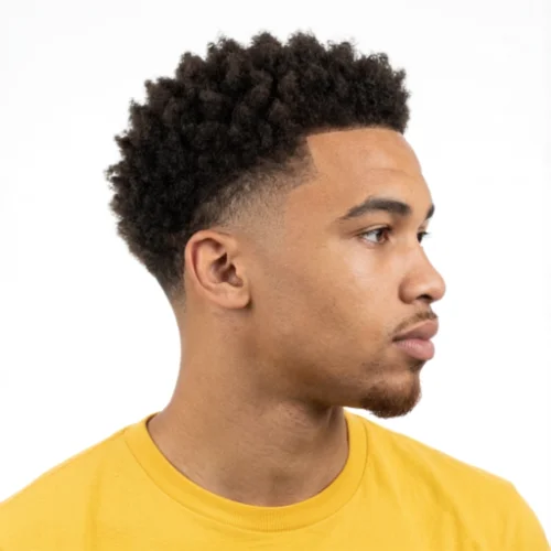 Black man with a natural afro and low taper fade haircut