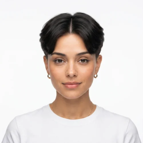 Man with thick hair and a low taper fade middle part featuring natural volume on a white background.
