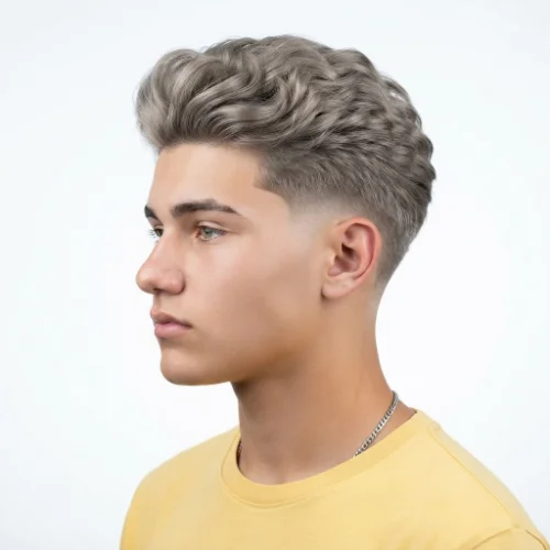 Man with a voluminous blonde quiff and low taper fade haircut on a white background.