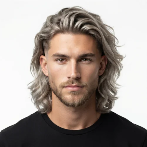 Man with blonde hair, a low taper fade, and a neatly groomed beard on a clean white background.